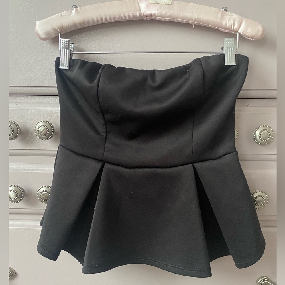 Black peplum top with shaped bust area , for beautiful fit. Side zip . Size L